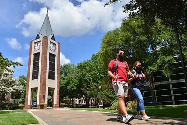 students walking in front of UIW clocktower